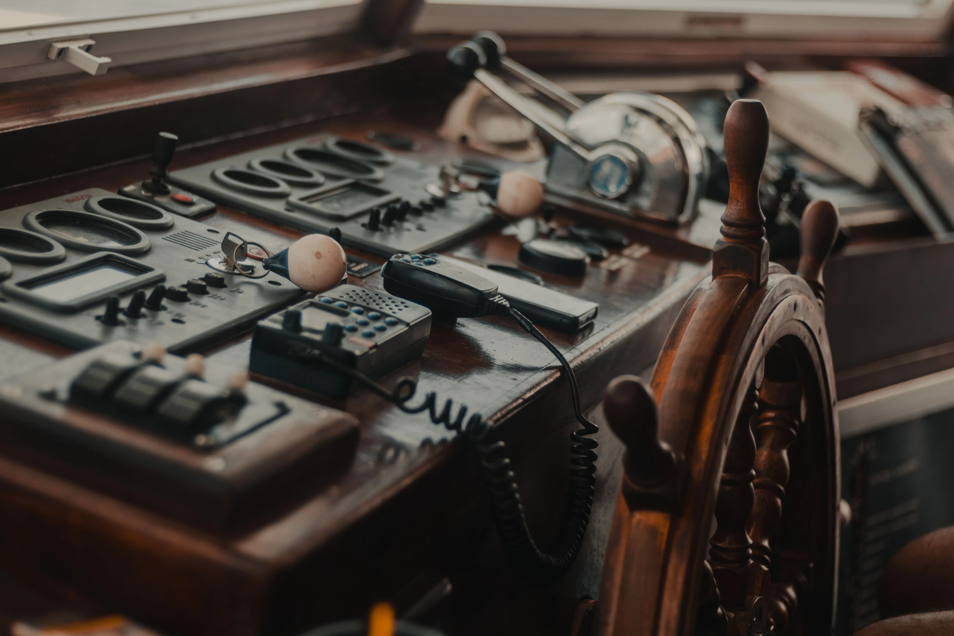 Traditional vessel controls and wheel inside a wheelhouse