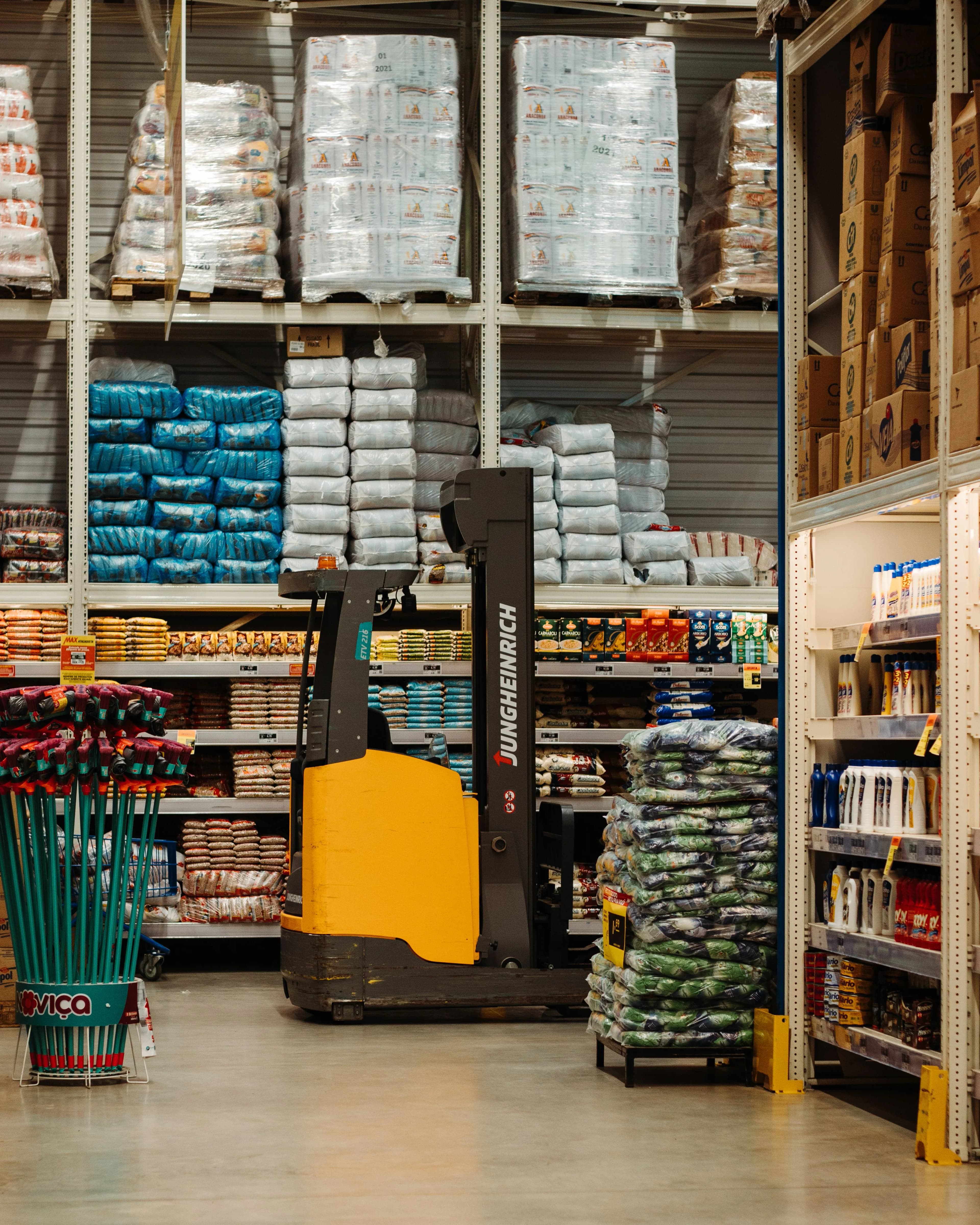 Warehouse stock arranged around material-handling equipment